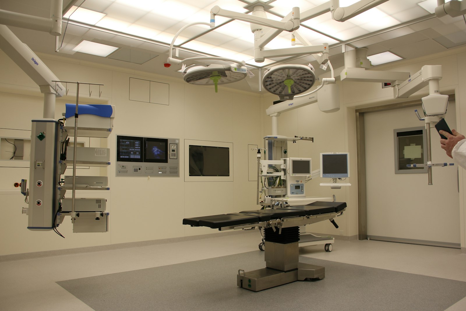 Quiet hospital corridor with natural light and empty seating